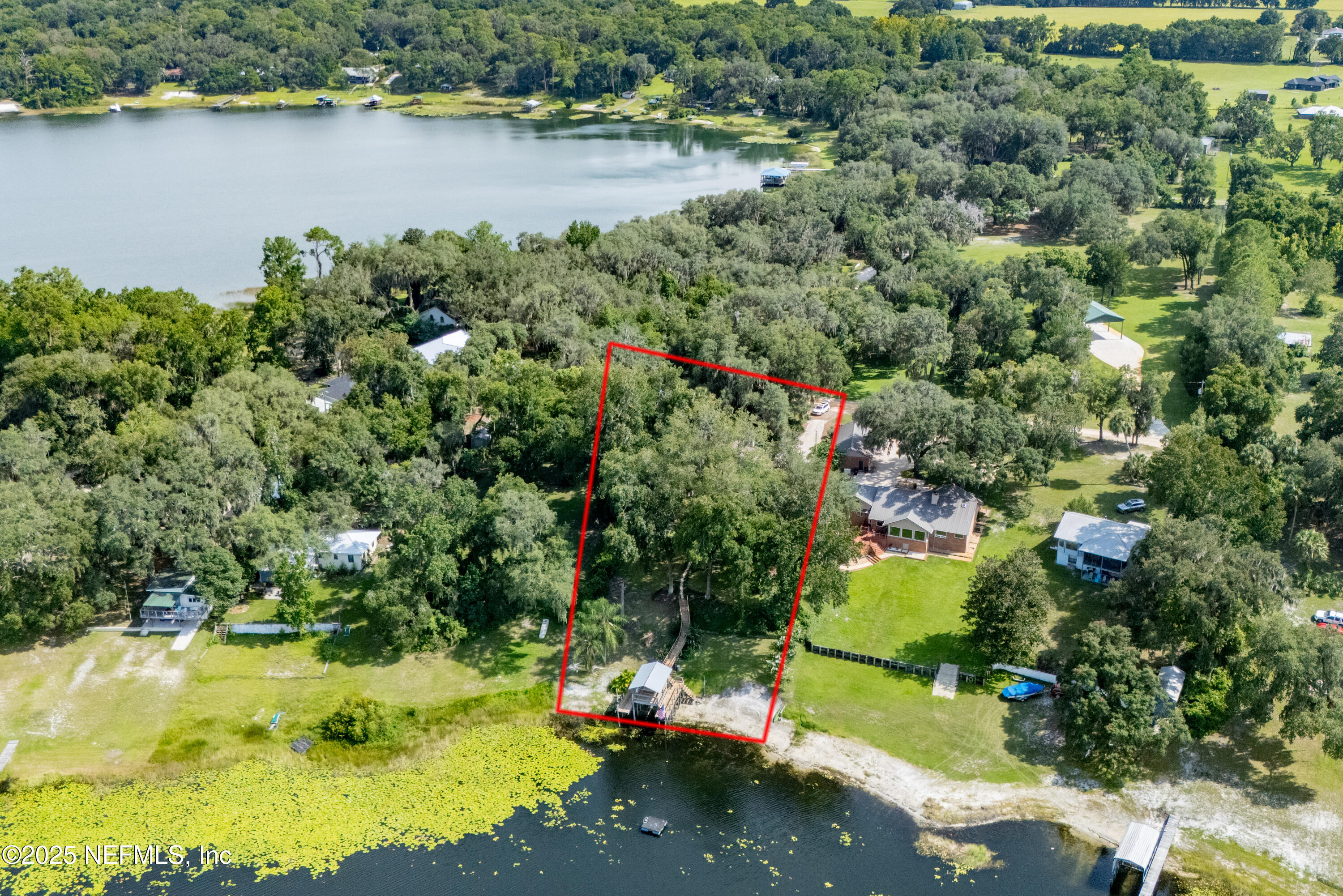 8166 Alderman Road Melrose, FL 32666 - Photo 43 of 94 an aerial view of a house with a yard and lake view