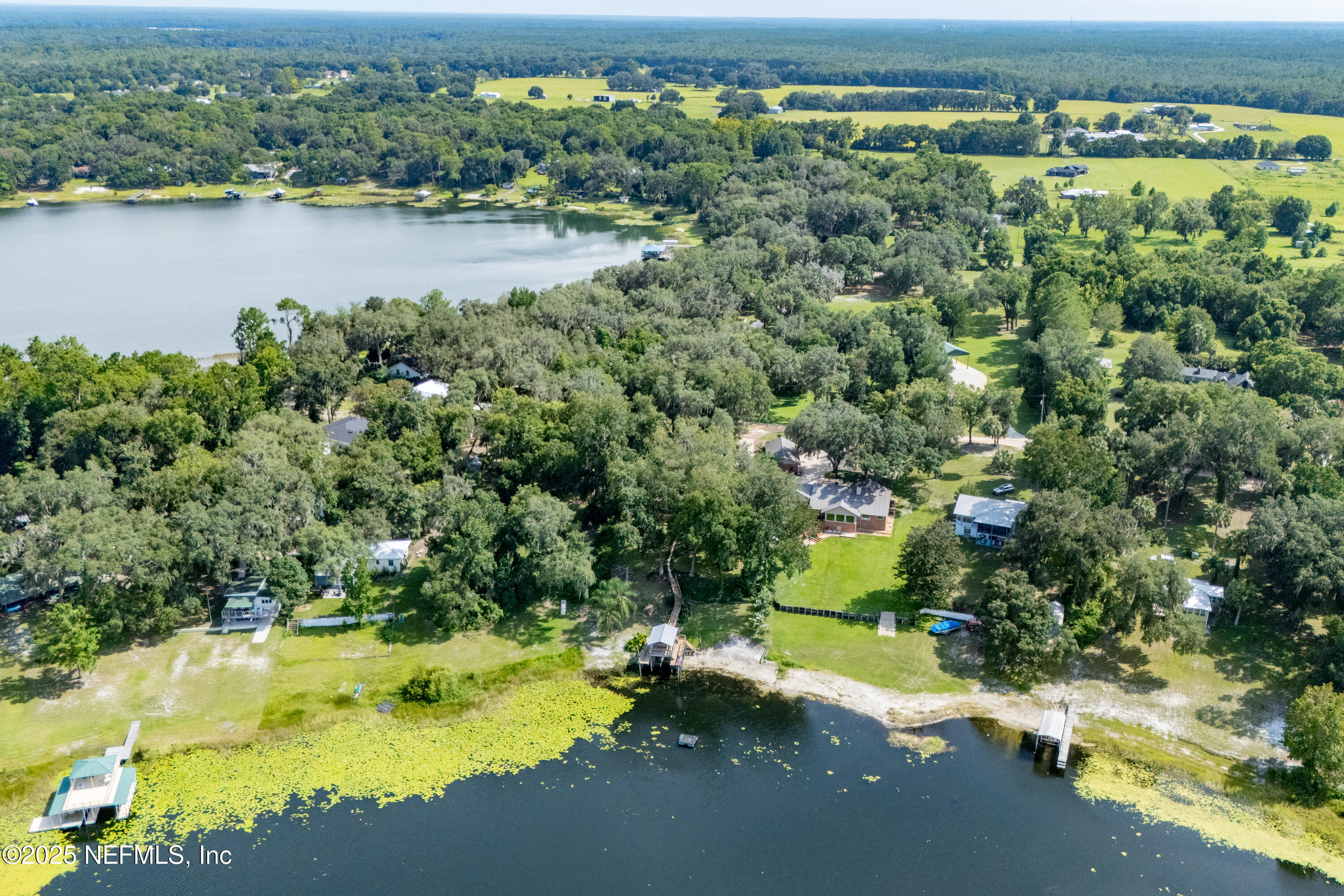 8166 Alderman Road Melrose, FL 32666 - Photo 44 of 94 an aerial view of residential houses with outdoor space and lake view