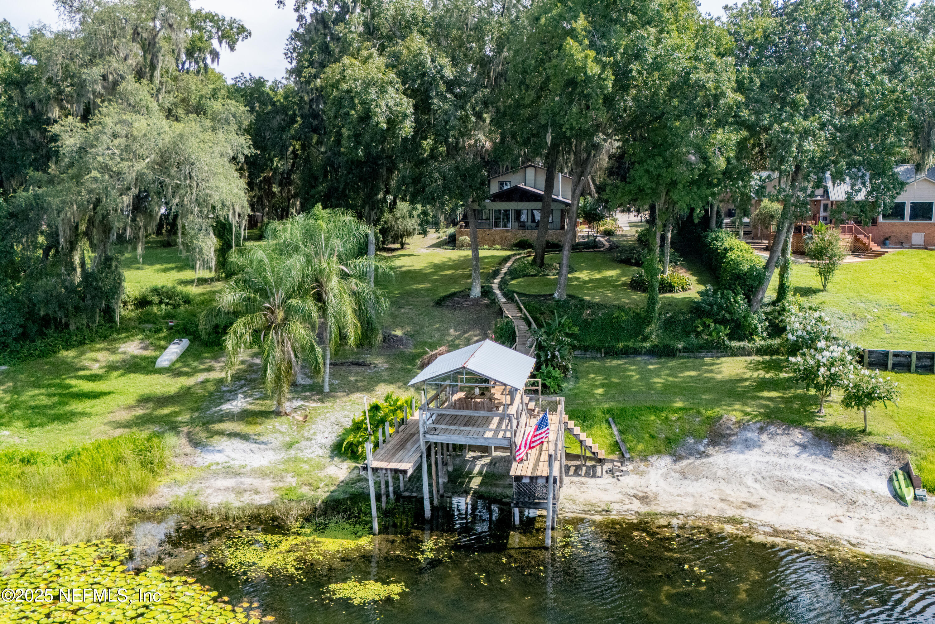 8166 Alderman Road Melrose, FL 32666 - Photo 46 of 94 a backyard of a house with a yard and outdoor seating