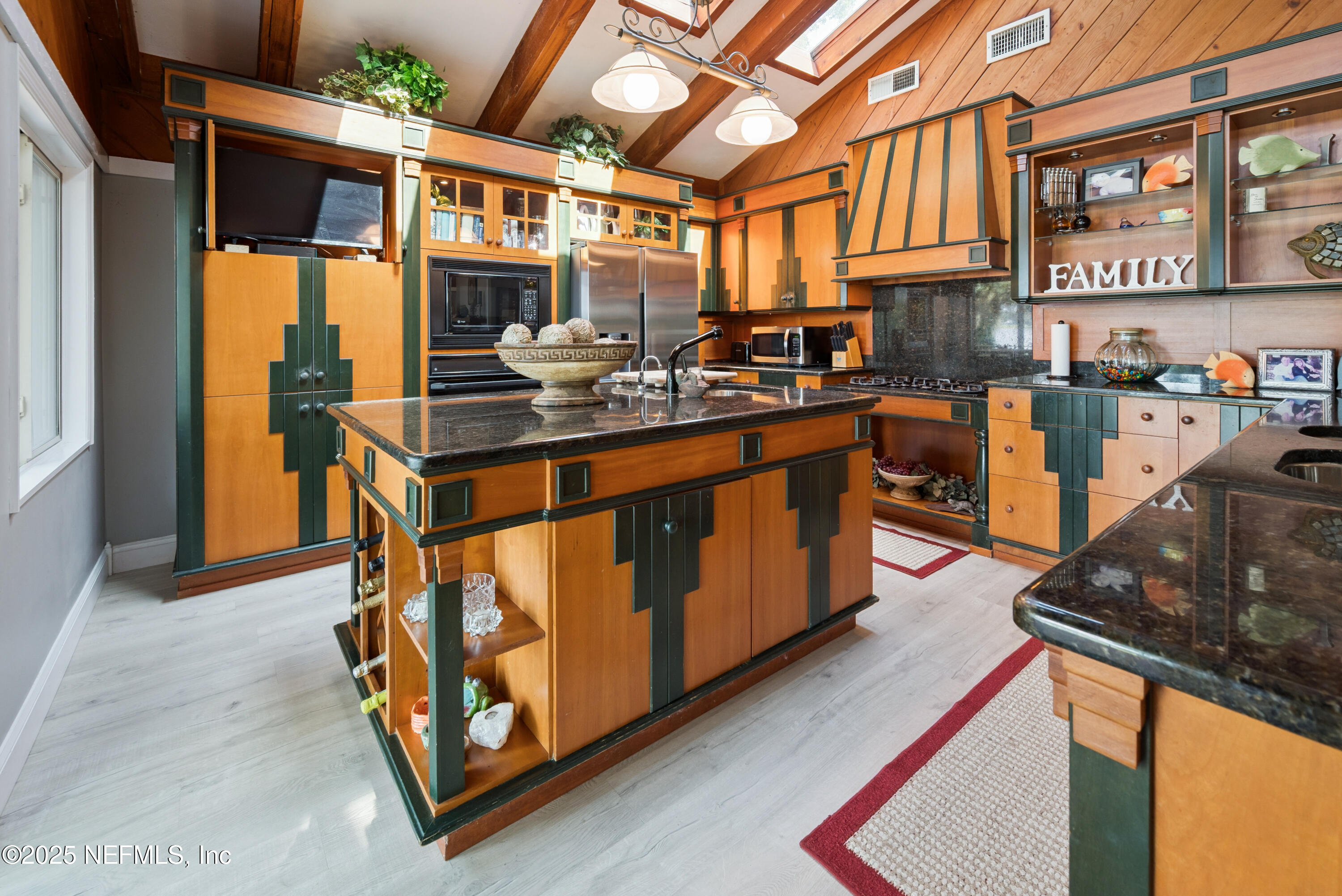 8166 Alderman Road Melrose, FL 32666 - Photo 65 of 94 a kitchen with stainless steel appliances granite countertop a stove a sink and a refrigerator