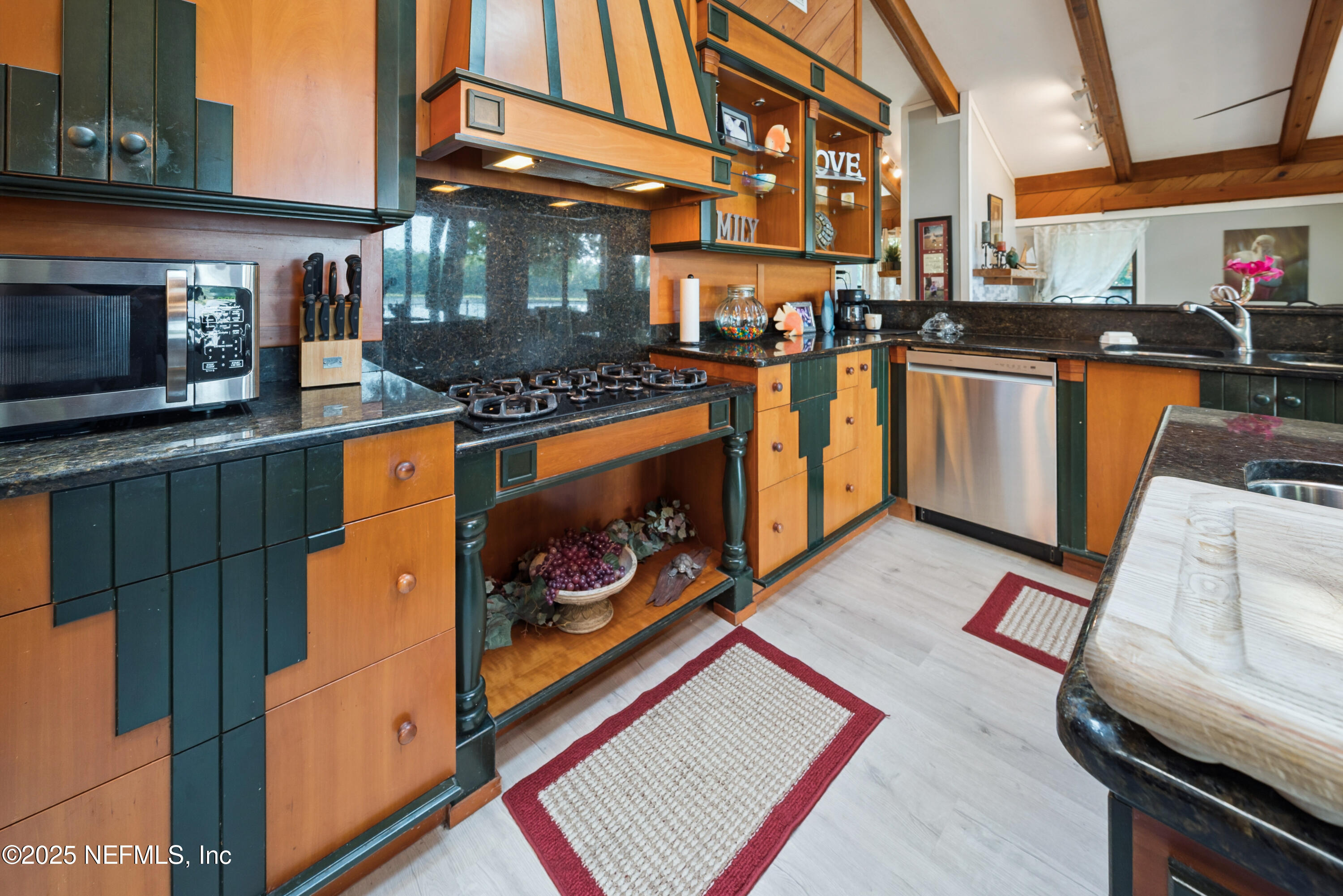 8166 Alderman Road Melrose, FL 32666 - Photo 67 of 94 a kitchen with stainless steel appliances granite countertop a stove a sink and a microwave