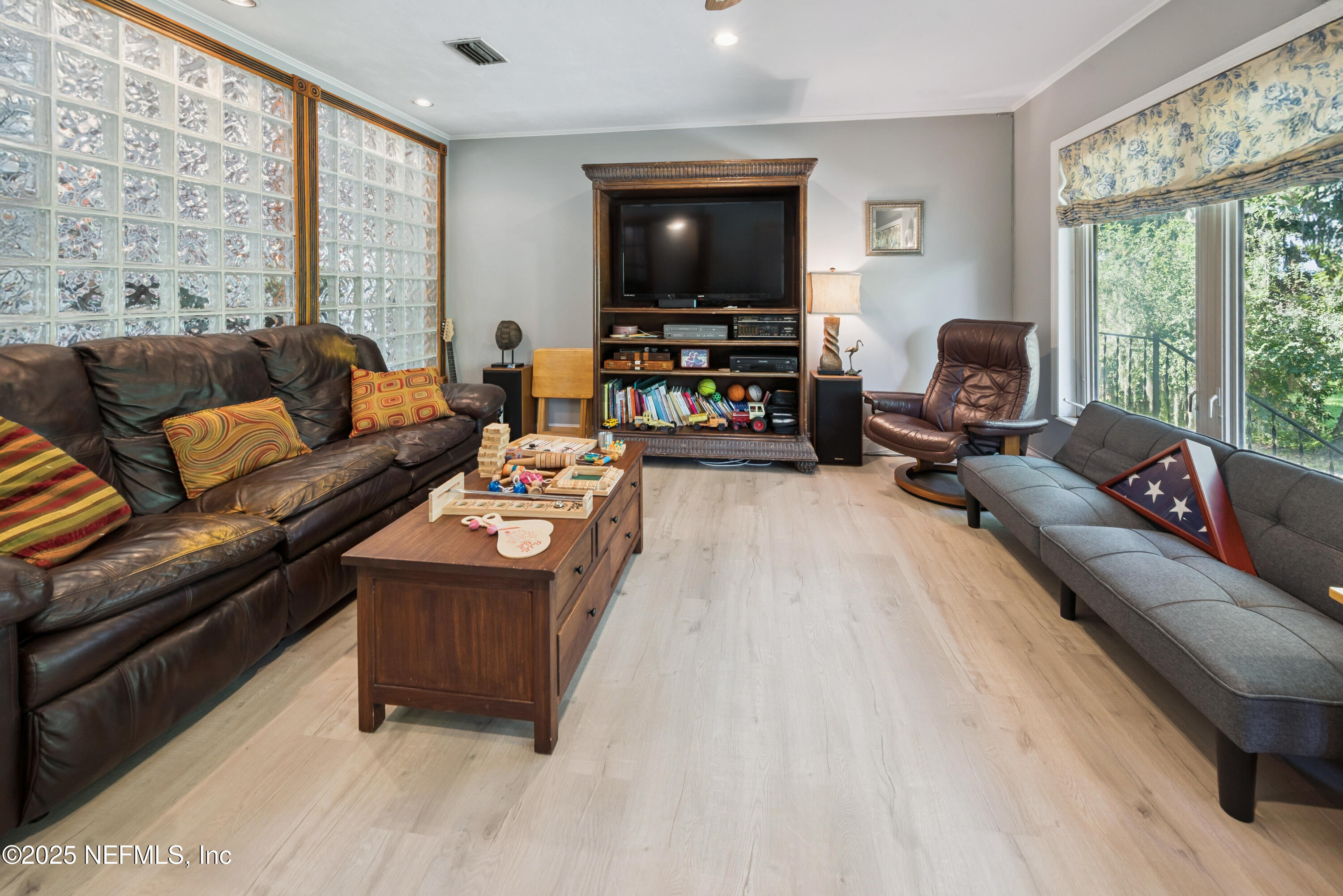 8166 Alderman Road Melrose, FL 32666 - Photo 75 of 94 a living room with furniture and a flat screen tv