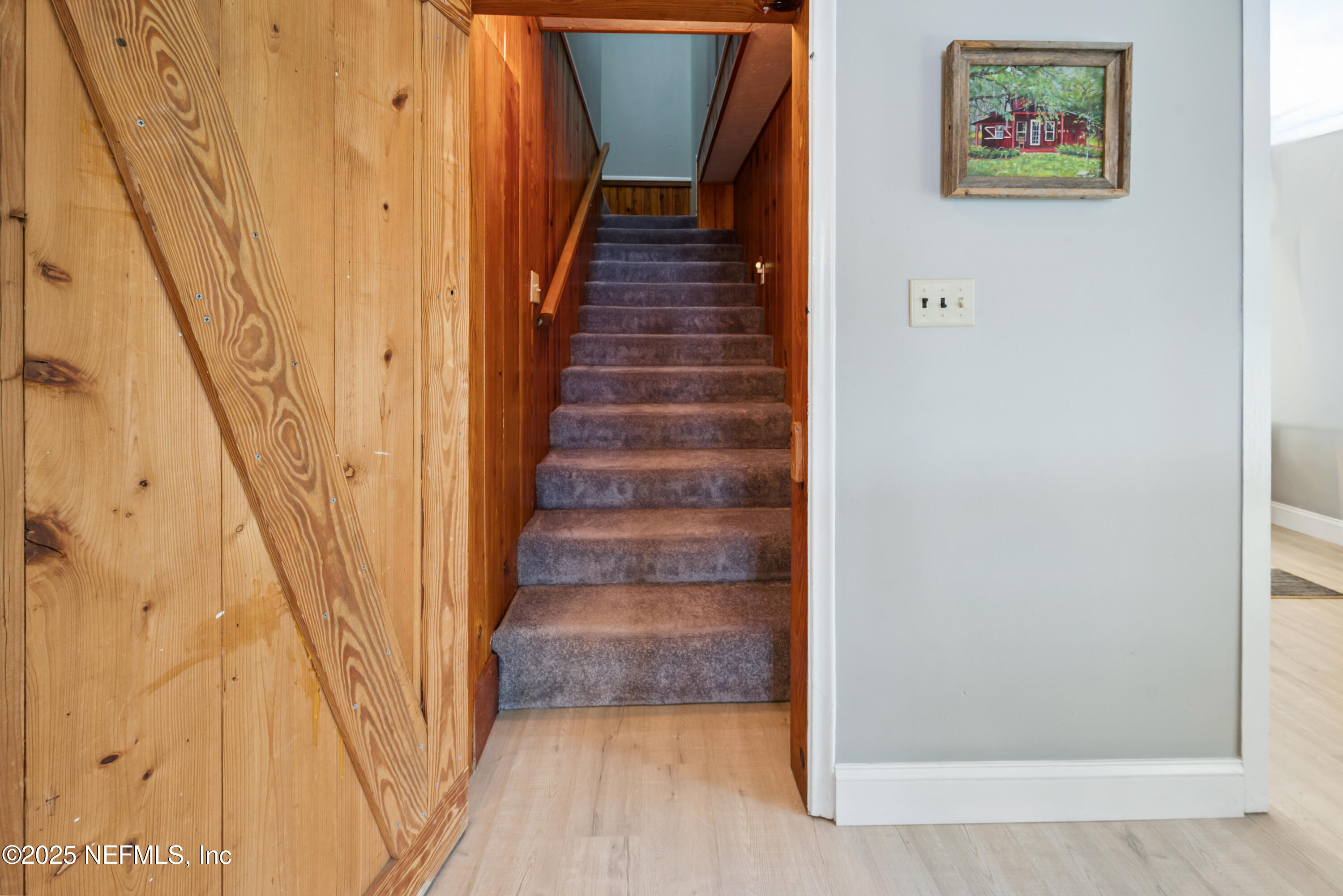 8166 Alderman Road Melrose, FL 32666 - Photo 81 of 94 a view of staircase with wooden floor and white walls