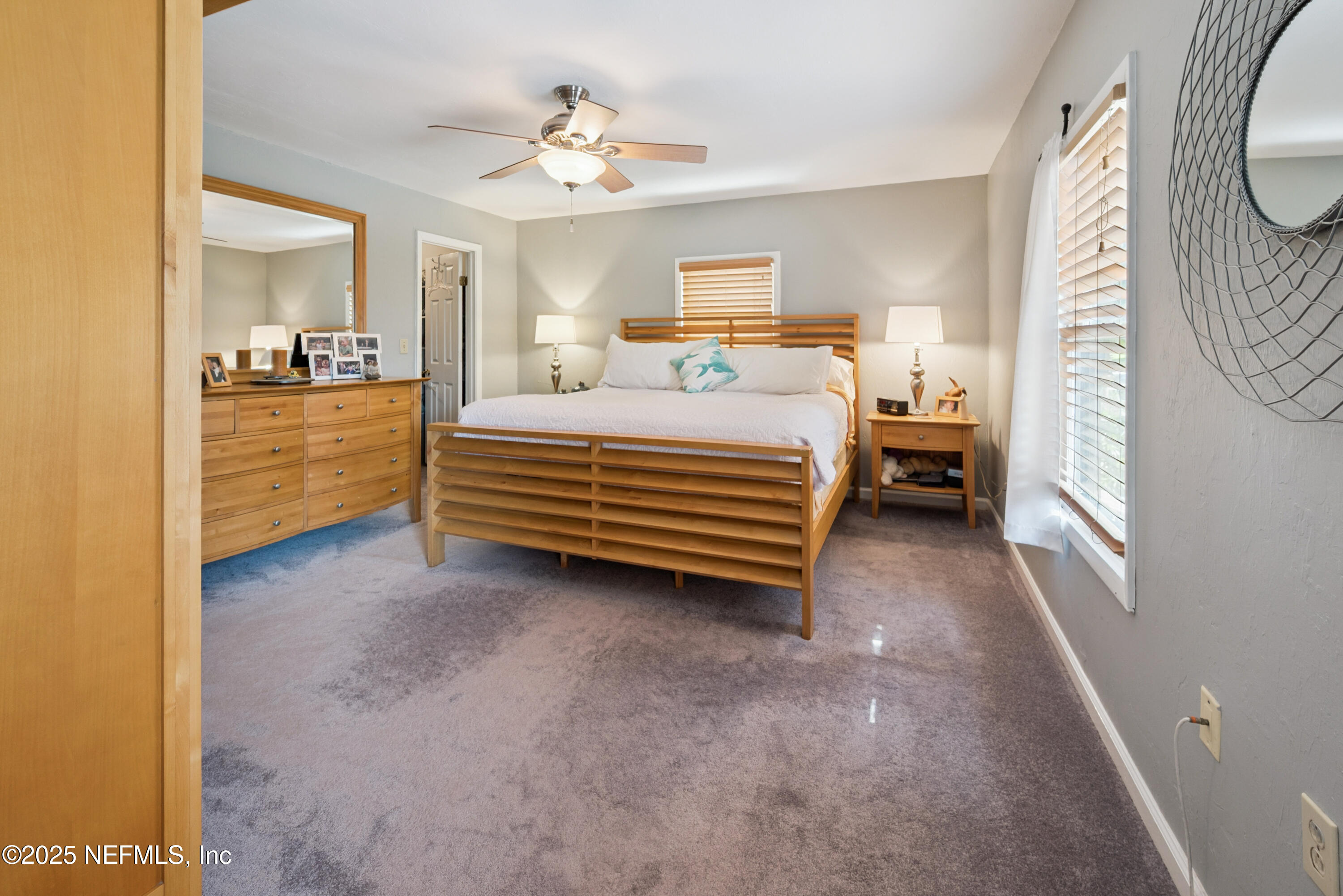 8166 Alderman Road Melrose, FL 32666 - Photo 84 of 94 a bedroom with a bed and a chandelier