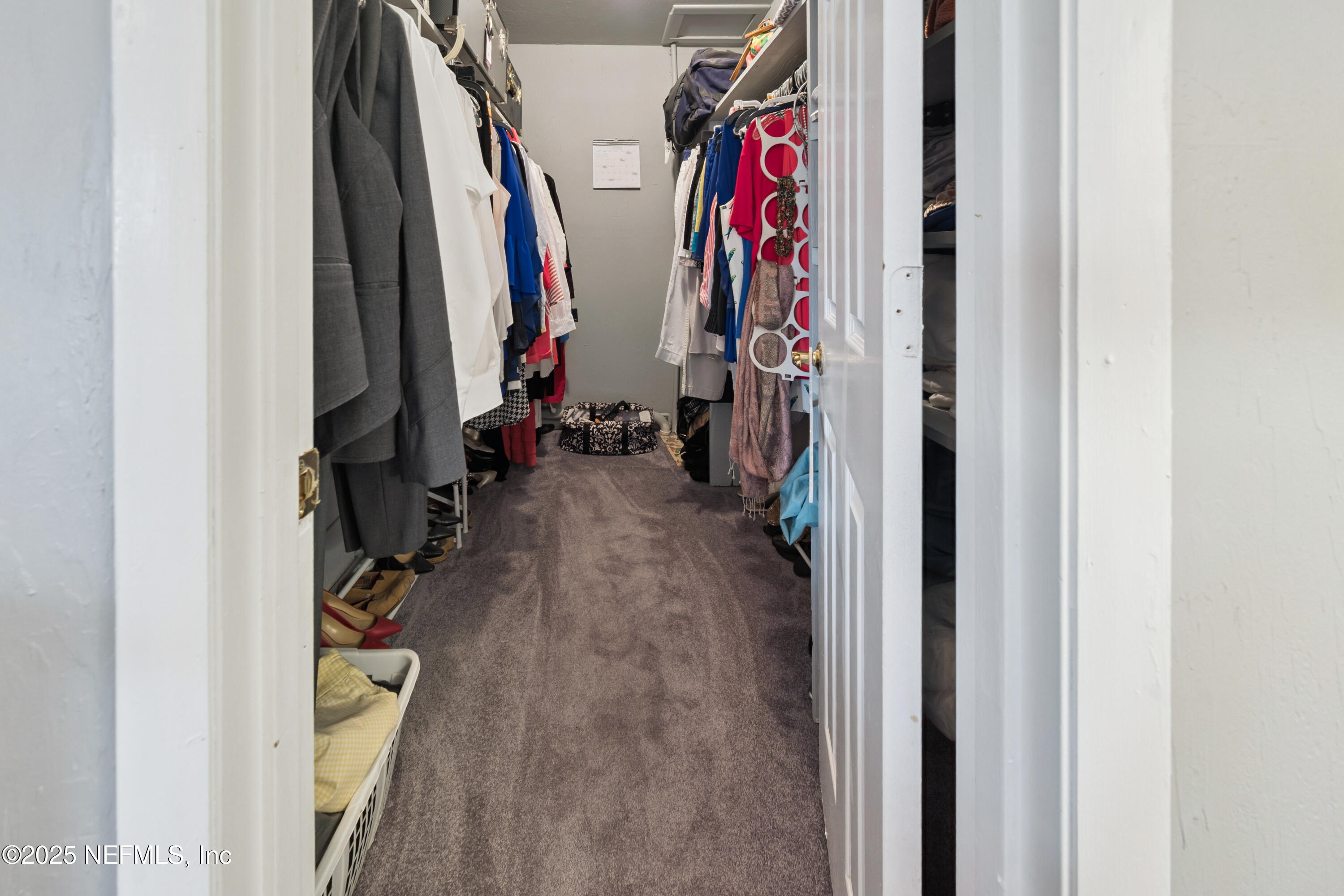 8166 Alderman Road Melrose, FL 32666 - Photo 86 of 94 a view of walk in closet with clothes