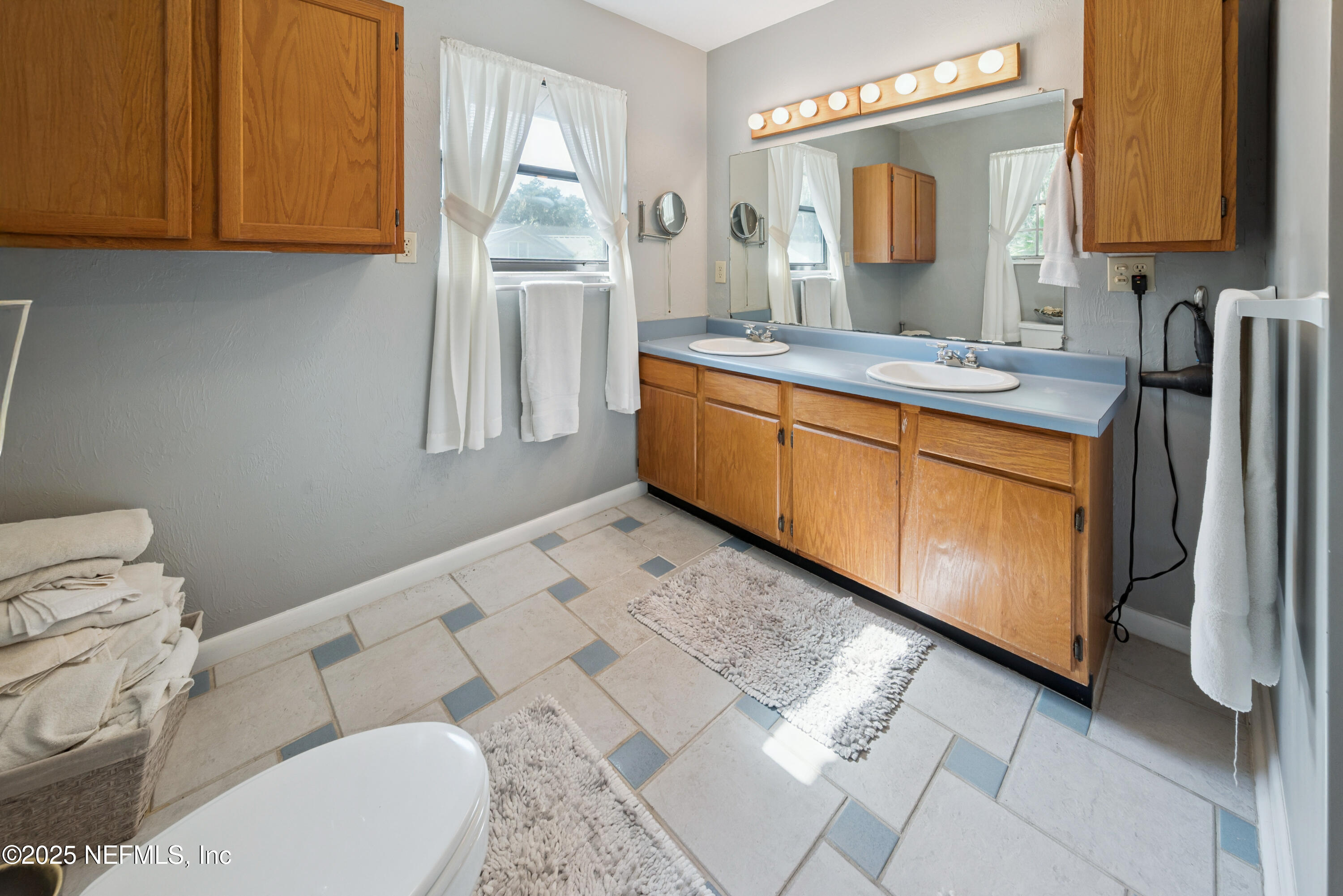 8166 Alderman Road Melrose, FL 32666 - Photo 87 of 94 a bathroom with a granite countertop sink and a mirror