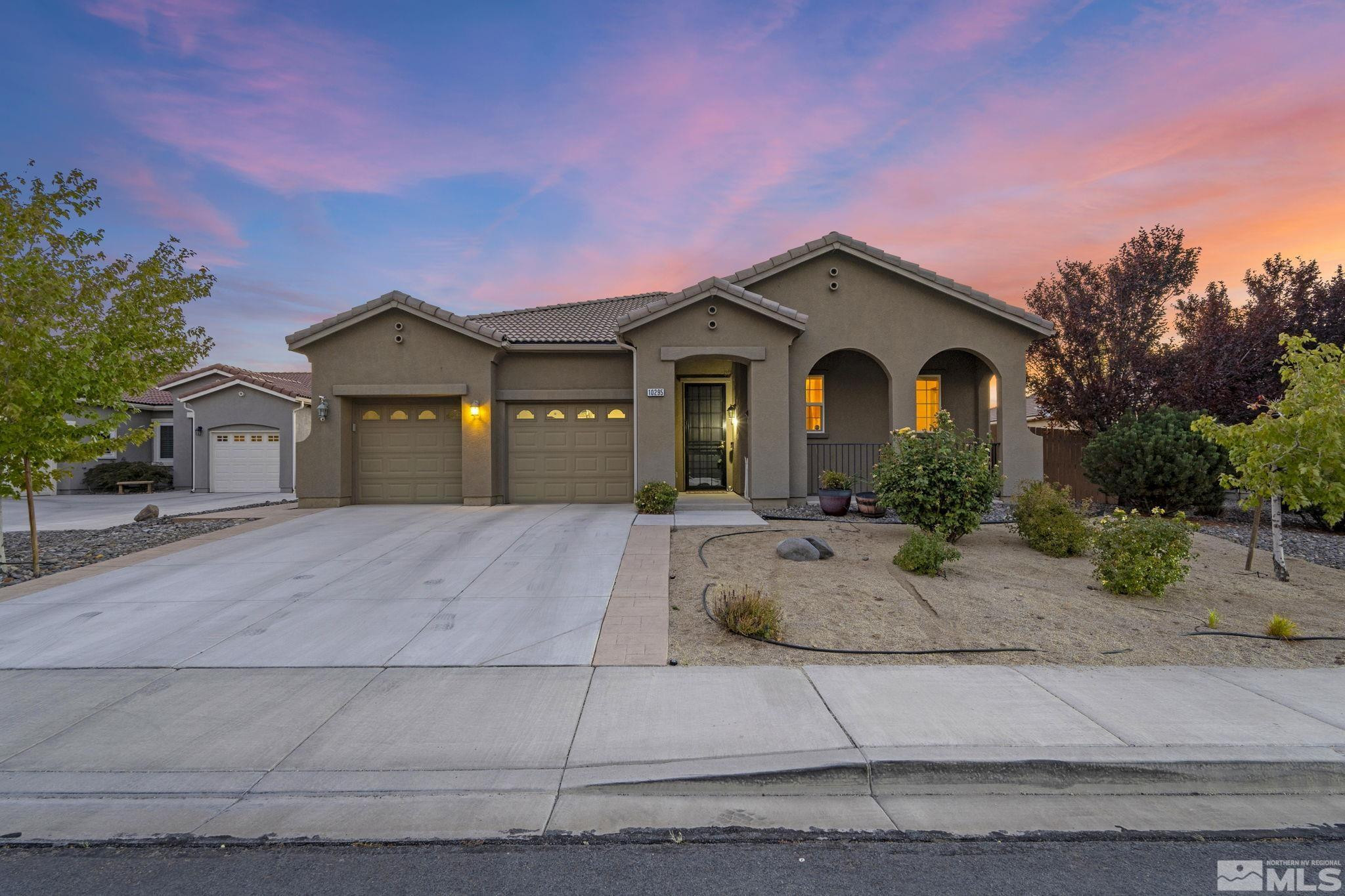 10295 Cavalry Circle Reno, NV 89521 - Photo 1 of 40 a front view of a house with garage and plants