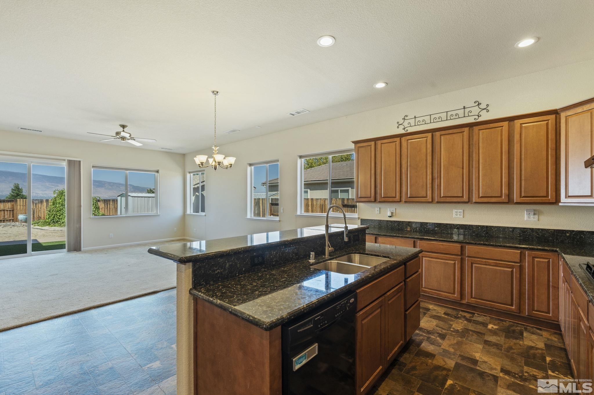 10295 Cavalry Circle Reno, NV 89521 - Photo 16 of 40 a kitchen with granite countertop a sink and cabinets