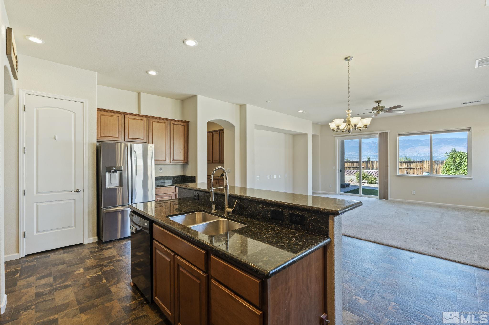10295 Cavalry Circle Reno, NV 89521 - Photo 17 of 40 a kitchen with granite countertop a sink a counter top space and stainless steel appliances