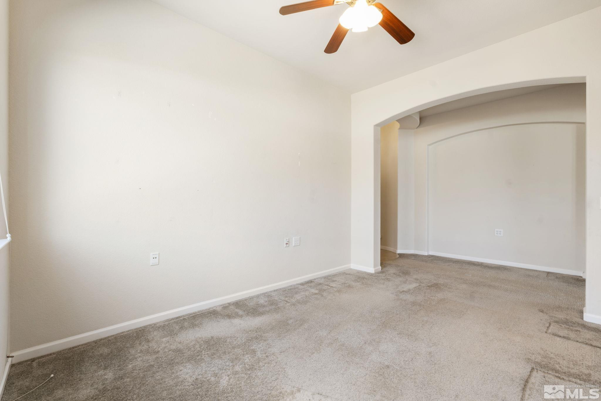 10295 Cavalry Circle Reno, NV 89521 - Photo 19 of 40 an empty room with a ceiling fan and carpet