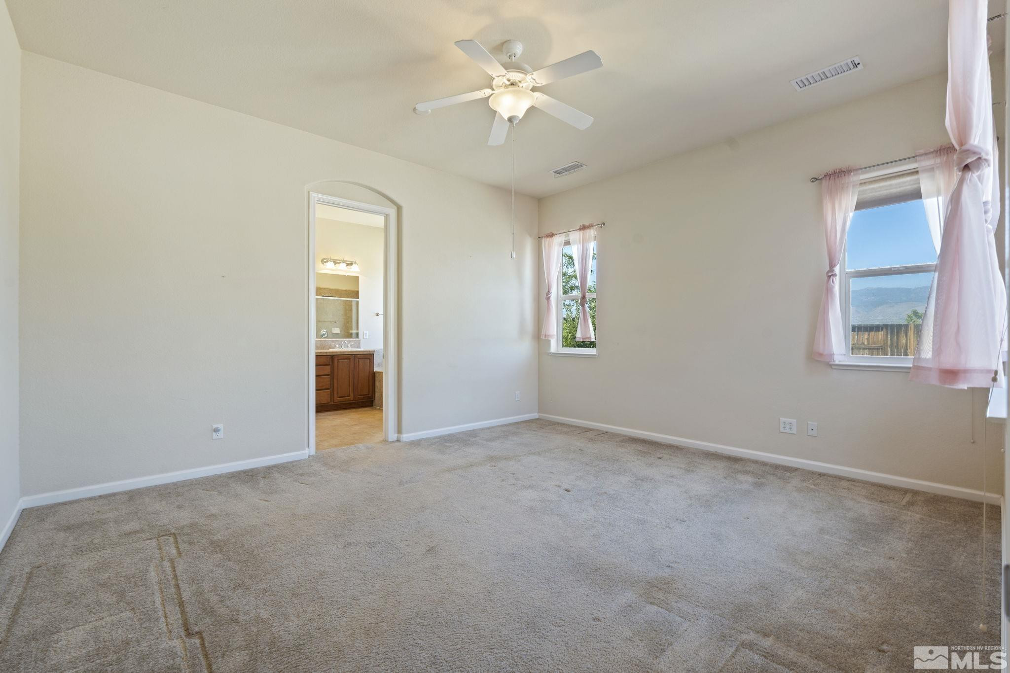 10295 Cavalry Circle Reno, NV 89521 - Photo 24 of 40 an empty room with windows and fan
