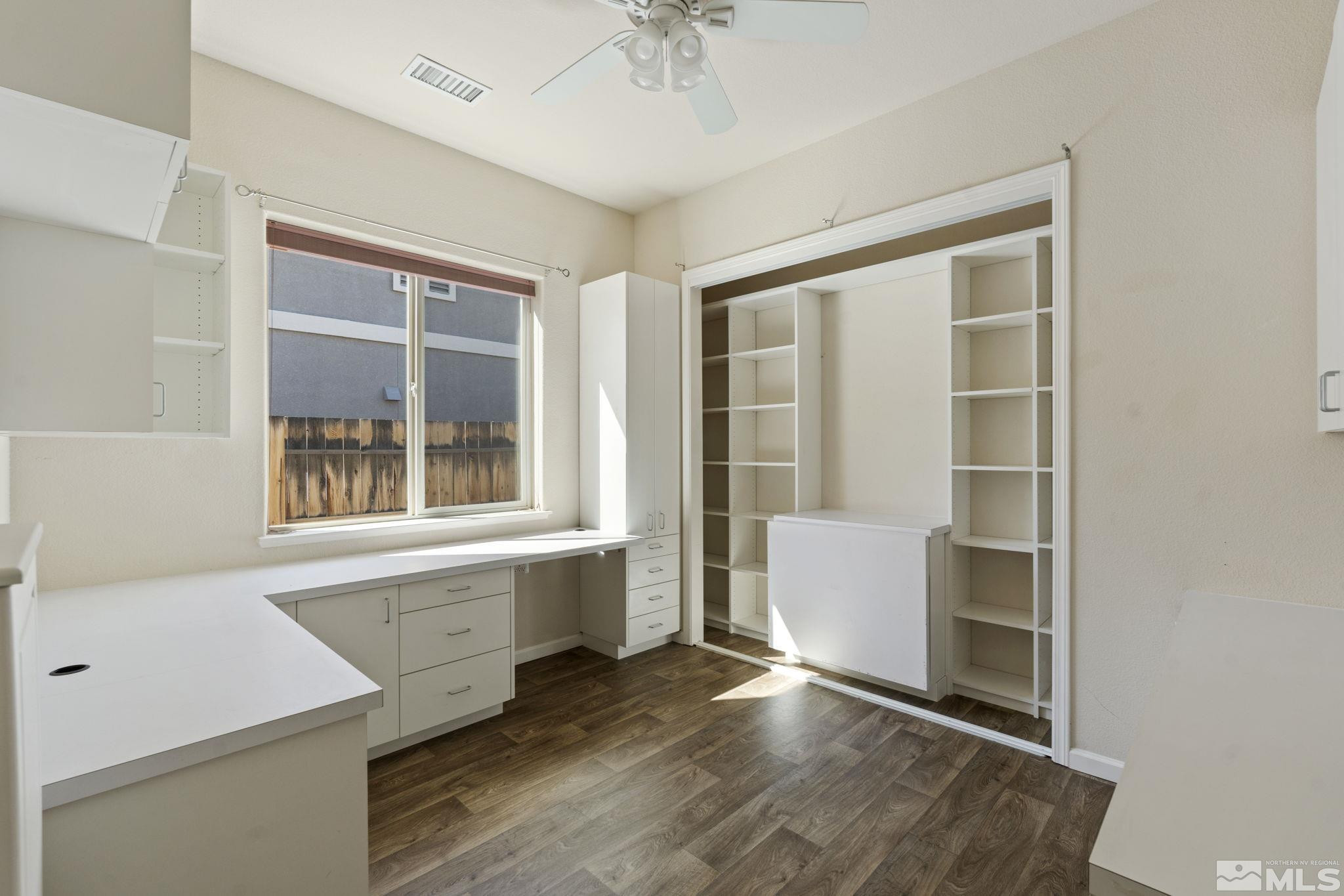 10295 Cavalry Circle Reno, NV 89521 - Photo 26 of 40 a view of an empty room with a window and wooden floor