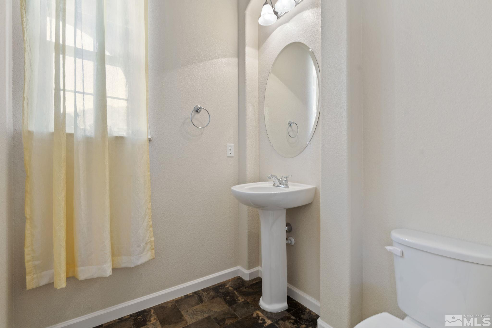 10295 Cavalry Circle Reno, NV 89521 - Photo 31 of 40 a bathroom with a sink a toilet and shower