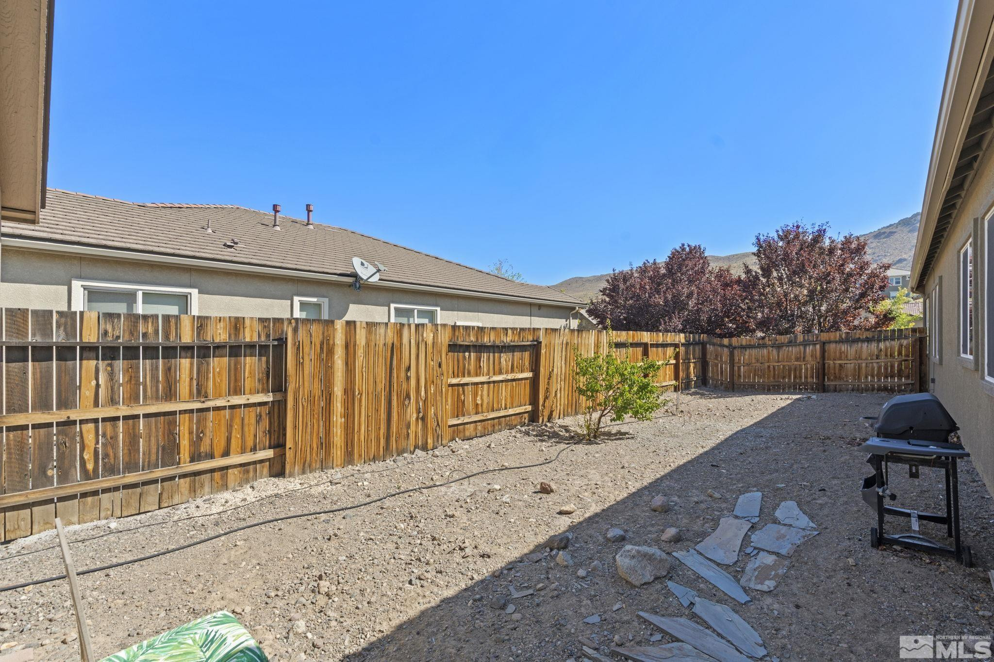 10295 Cavalry Circle Reno, NV 89521 - Photo 40 of 40 a view of a house with a floor to ceiling window and wooden fence