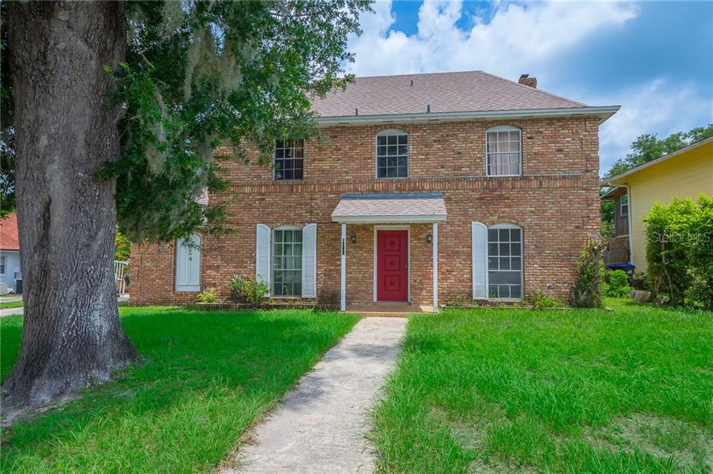 5891 Sir Henry Road Orlando, FL 32808 - Photo 1 of 1 a front view of a house with a yard and garage