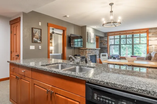 a kitchen with granite countertop a sink and a window