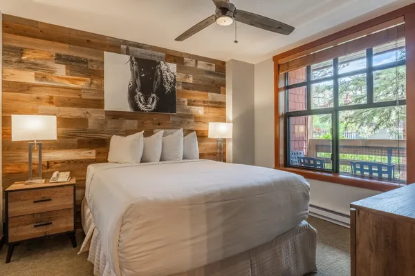 a bedroom with a bed and a large window