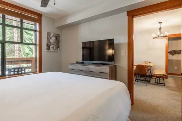 a bedroom with a bed and a flat screen tv