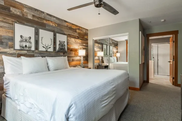 a bedroom with a large bed and furniture