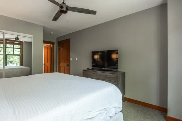 a bedroom with a bed and a flat screen tv