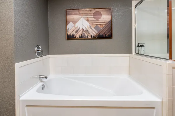 a bathroom with bathtub and window