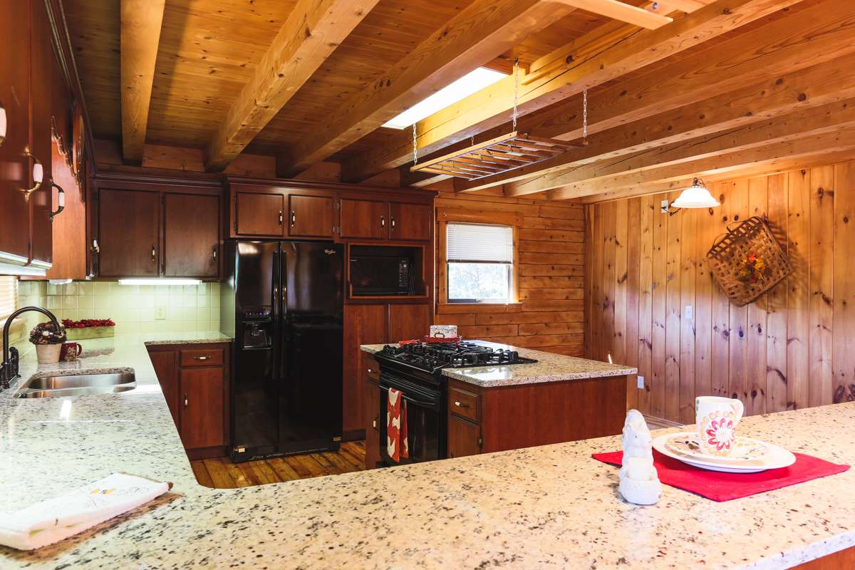 917 Roman Road Mount Sidney, VA 24467 - Photo 9 of 45 a kitchen with a stove and a refrigerator