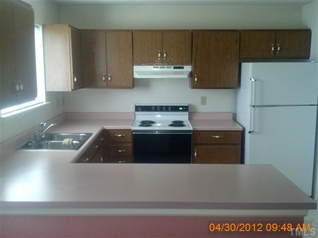 1815 Collier Road Durham, NC 27707 - Photo 4 of 7 a kitchen with a stove and a refrigerator