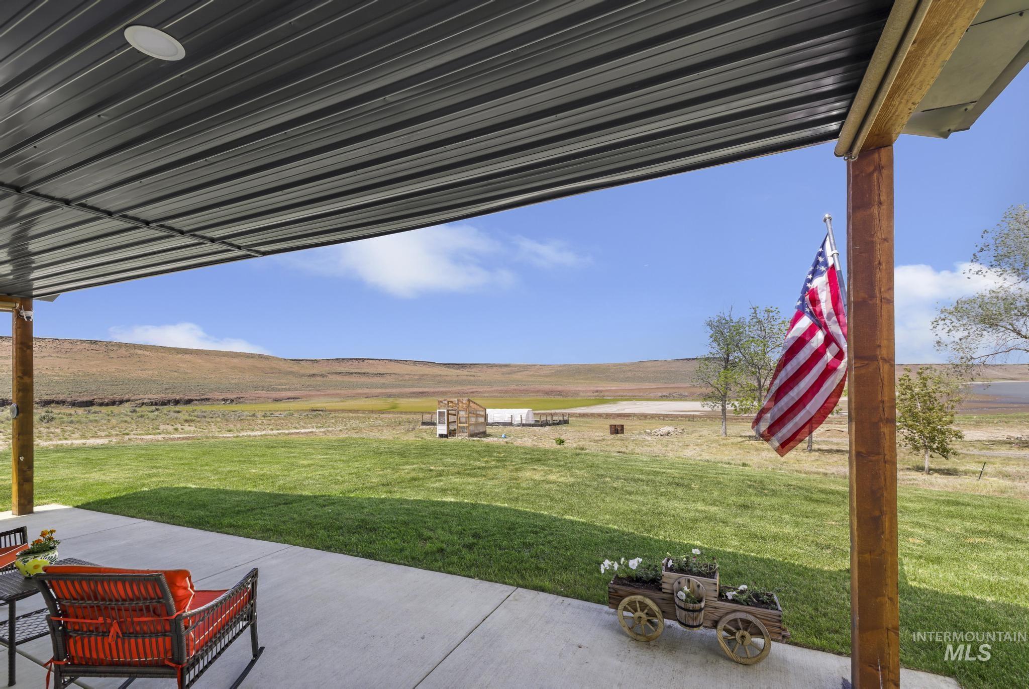 758 Cedar Crk Road Rogerson, ID 83302 - Photo 35 of 50 Covered patio with a corrugated metal ceiling, recessed lighting, and exposed wood support beams