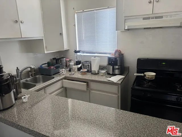 a kitchen with a sink and cabinets