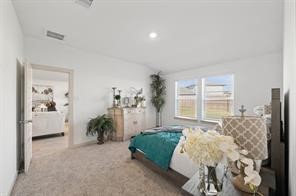 8027 Milam Lane Rosharon, TX 77583 - Photo 11 of 18 a spacious bedroom with a bed and a couch