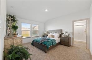 8027 Milam Lane Rosharon, TX 77583 - Photo 15 of 18 a spacious bedroom with a bed windows and a potted plant