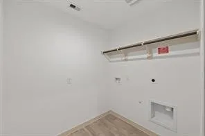 a view of storage and utility room with washer and dryer