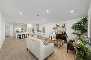 a living room with furniture and a potted plant