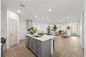 a kitchen with sink stove and refrigerator