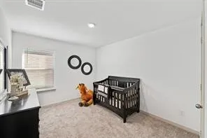 a spacious bedroom with a bed and a couch