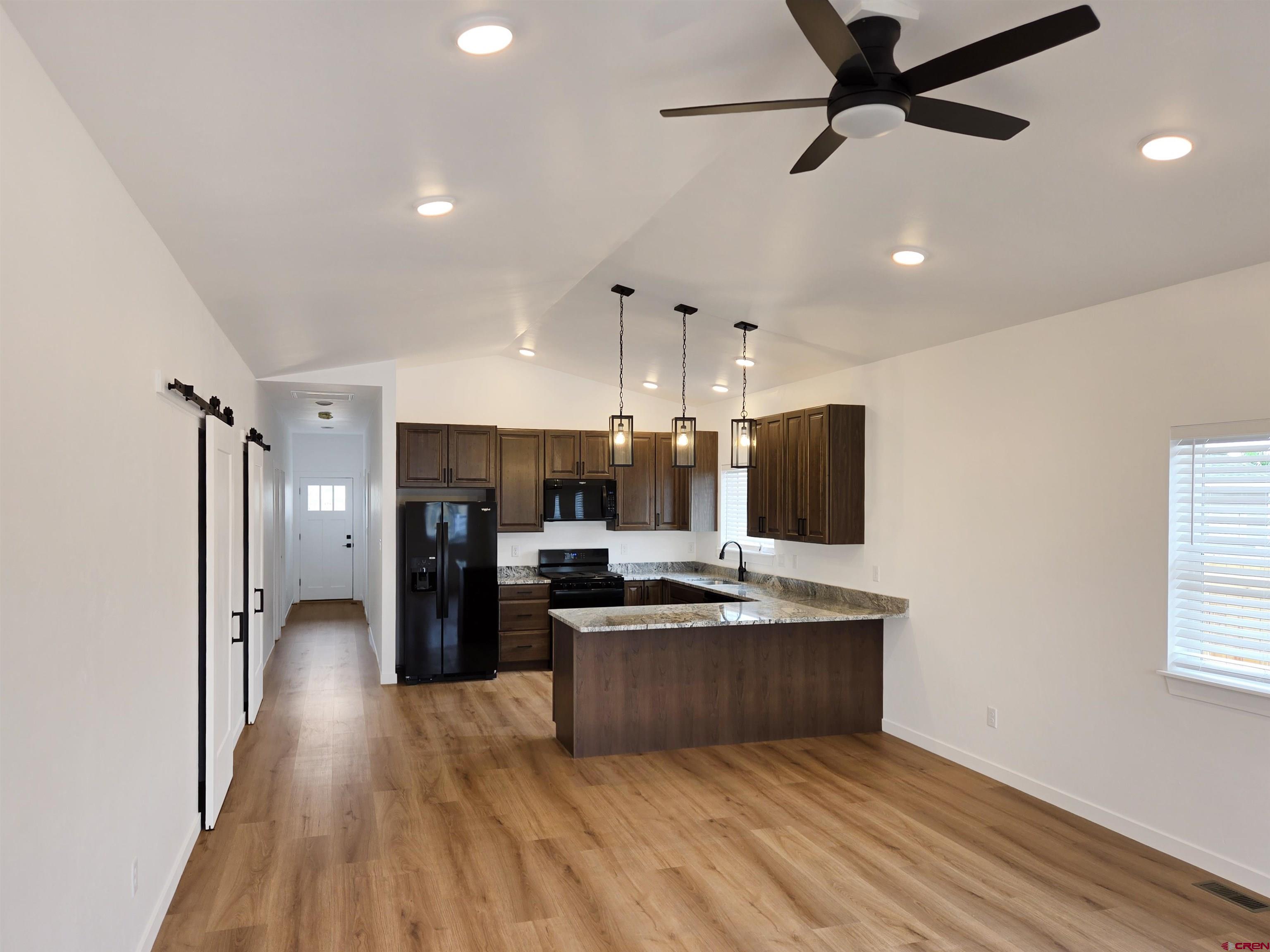1456 Acoma Street Cortez, CO 81321 - Photo 4 of 26 a view of kitchen with sink microwave and refrigerator