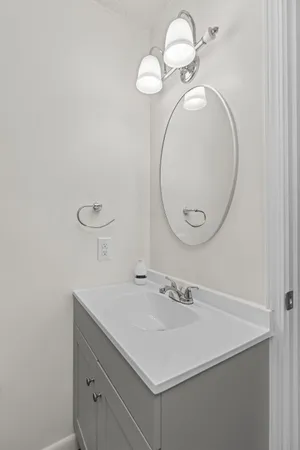 a bathroom with a sink mirror and vanity