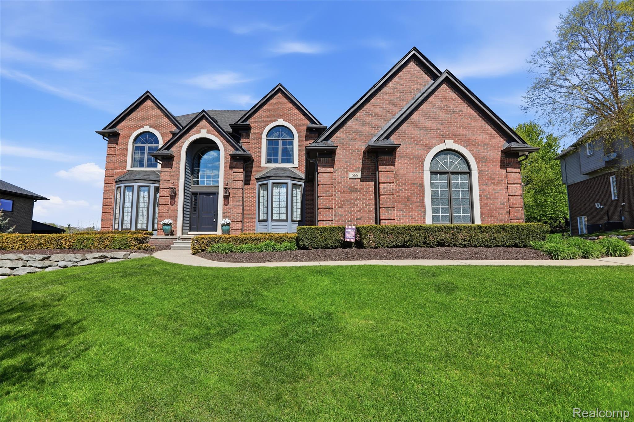 668 Springview Drive Rochester, MI 48307 - Photo 2 of 90 Traditional home with brick siding and a front yard