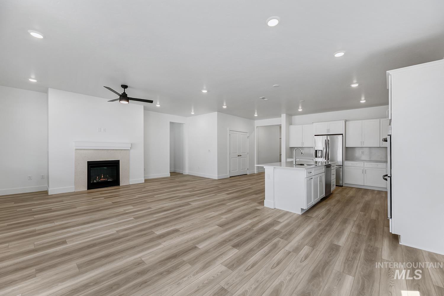 4548 West Wapoot Street Meridian, ID 83646 - Photo 3 of 17 Open-concept living area featuring wood-finish flooring and recessed lighting throughout