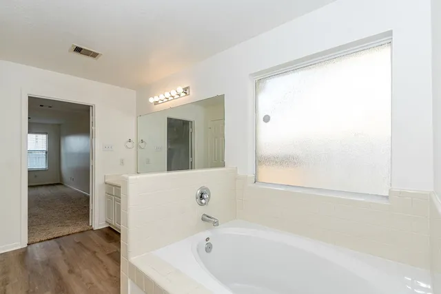a bathroom with a bathtub and a shower