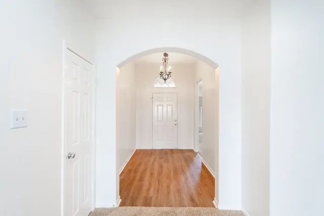 a view of a livingroom with wooden floor and a window