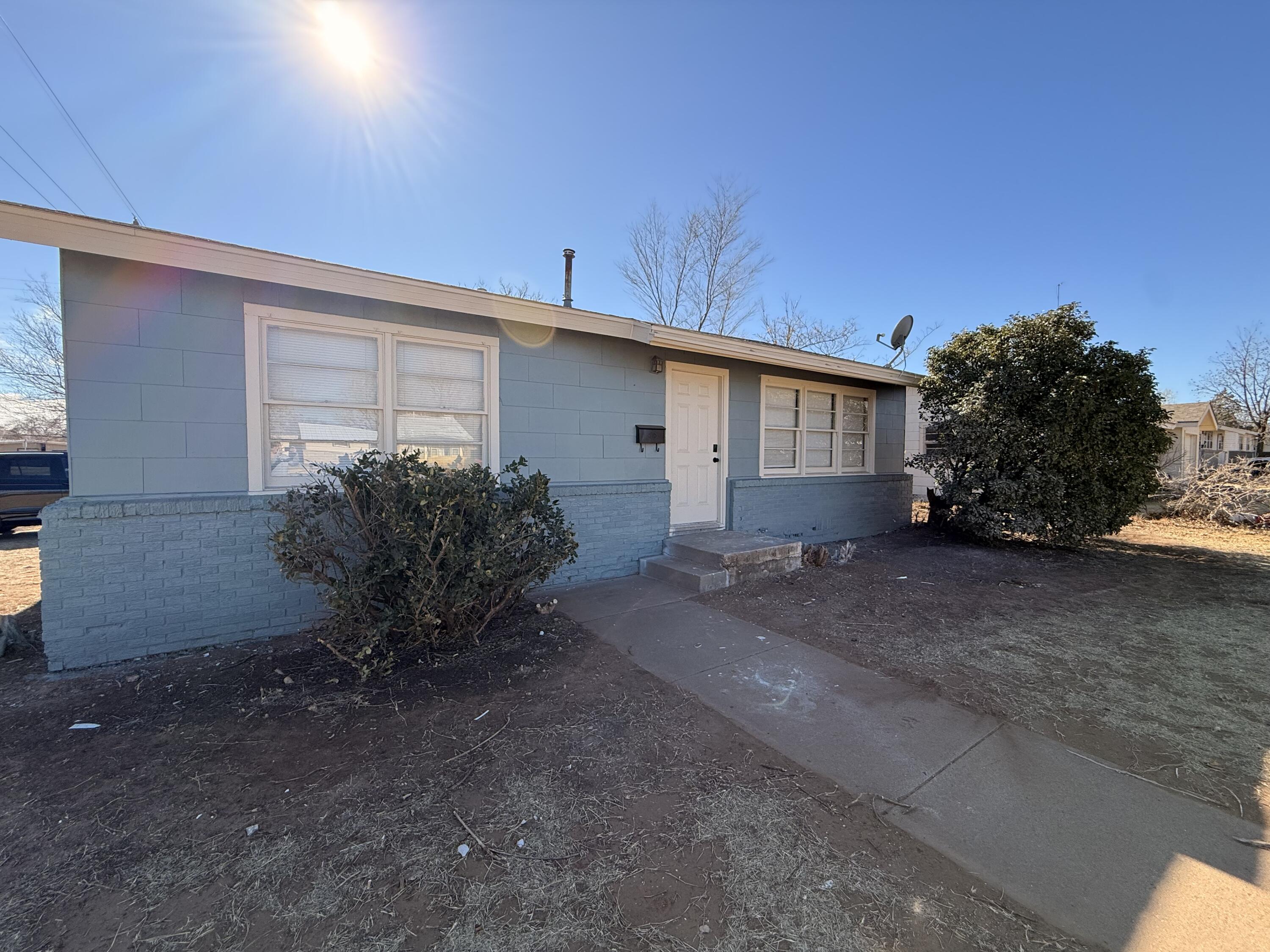 a view of a house with a yard and garage