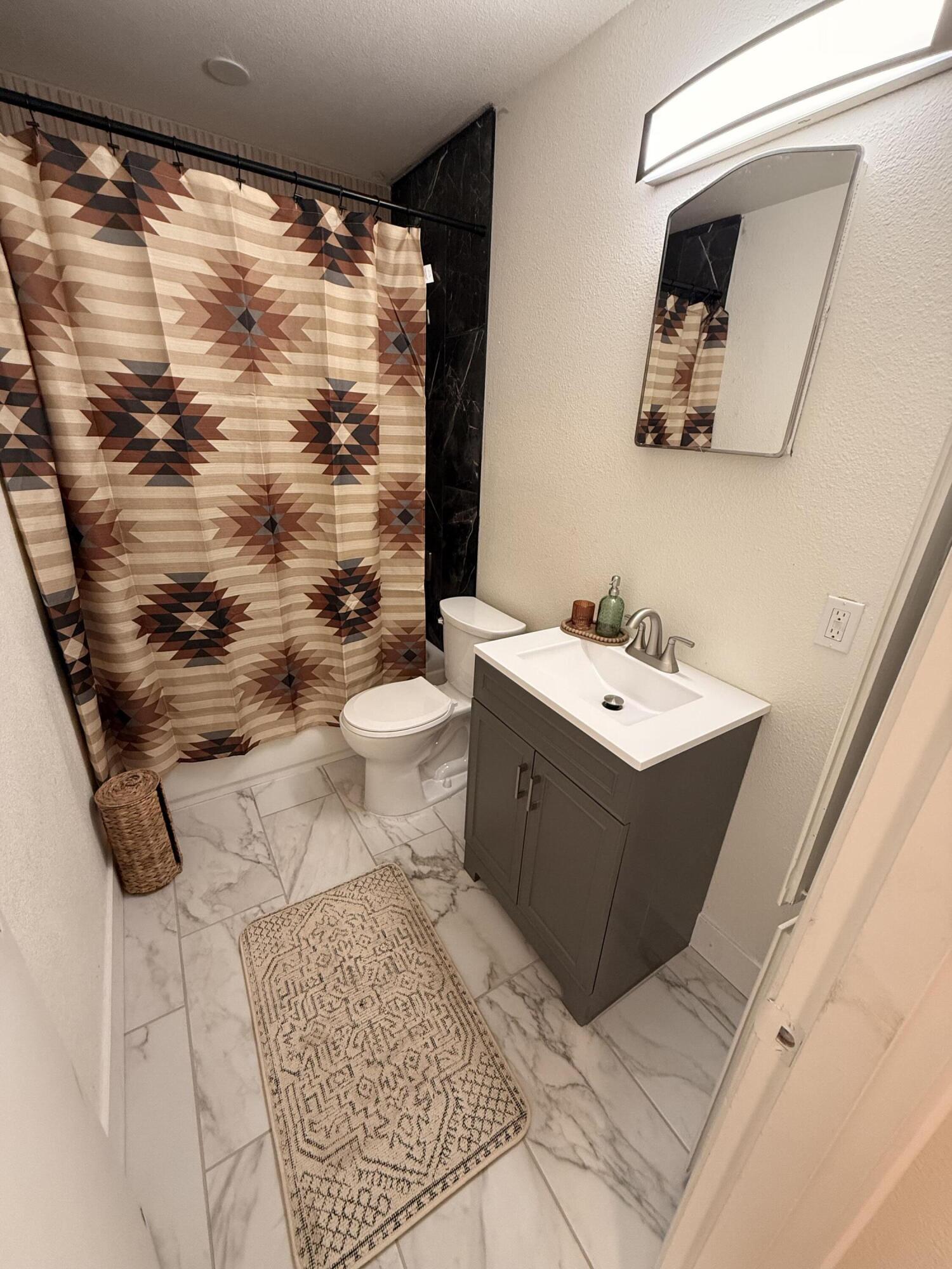 4601 43rd Street Lubbock, TX 79414 - Photo 2 of 12 a bathroom with a sink mirror and toilet