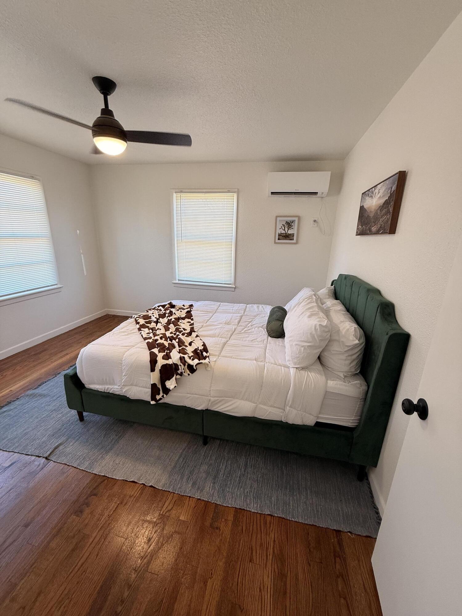 4601 43rd Street Lubbock, TX 79414 - Photo 7 of 12 a bedroom with a bed and wooden floor