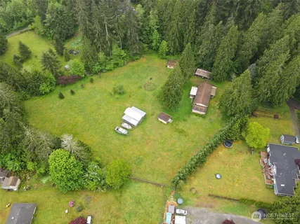an aerial view of a house with a yard
