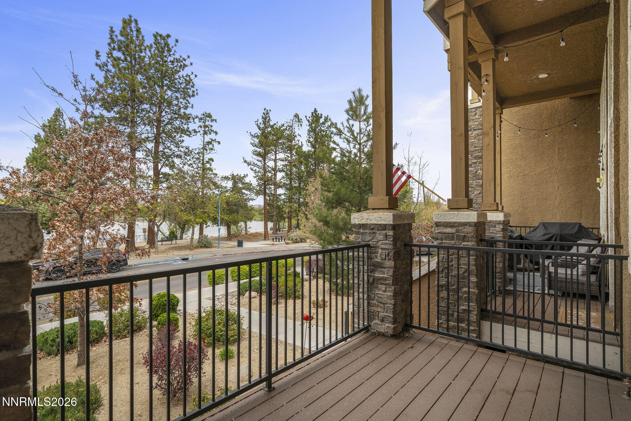 a view of a balcony with wooden floor and fence