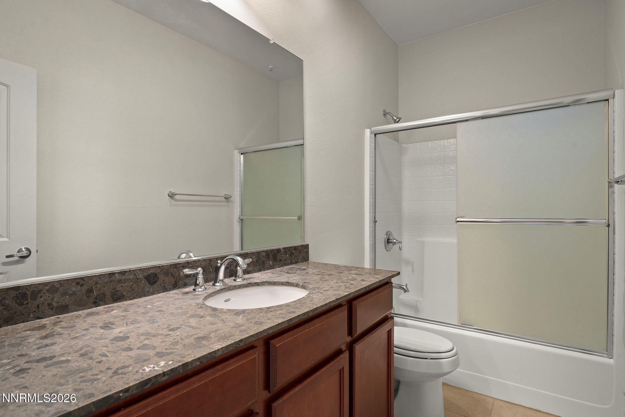 2490 Eastshore Place, Unit 104 Reno, NV 89509 - Photo 18 of 29 a bathroom with a granite countertop sink toilet and shower