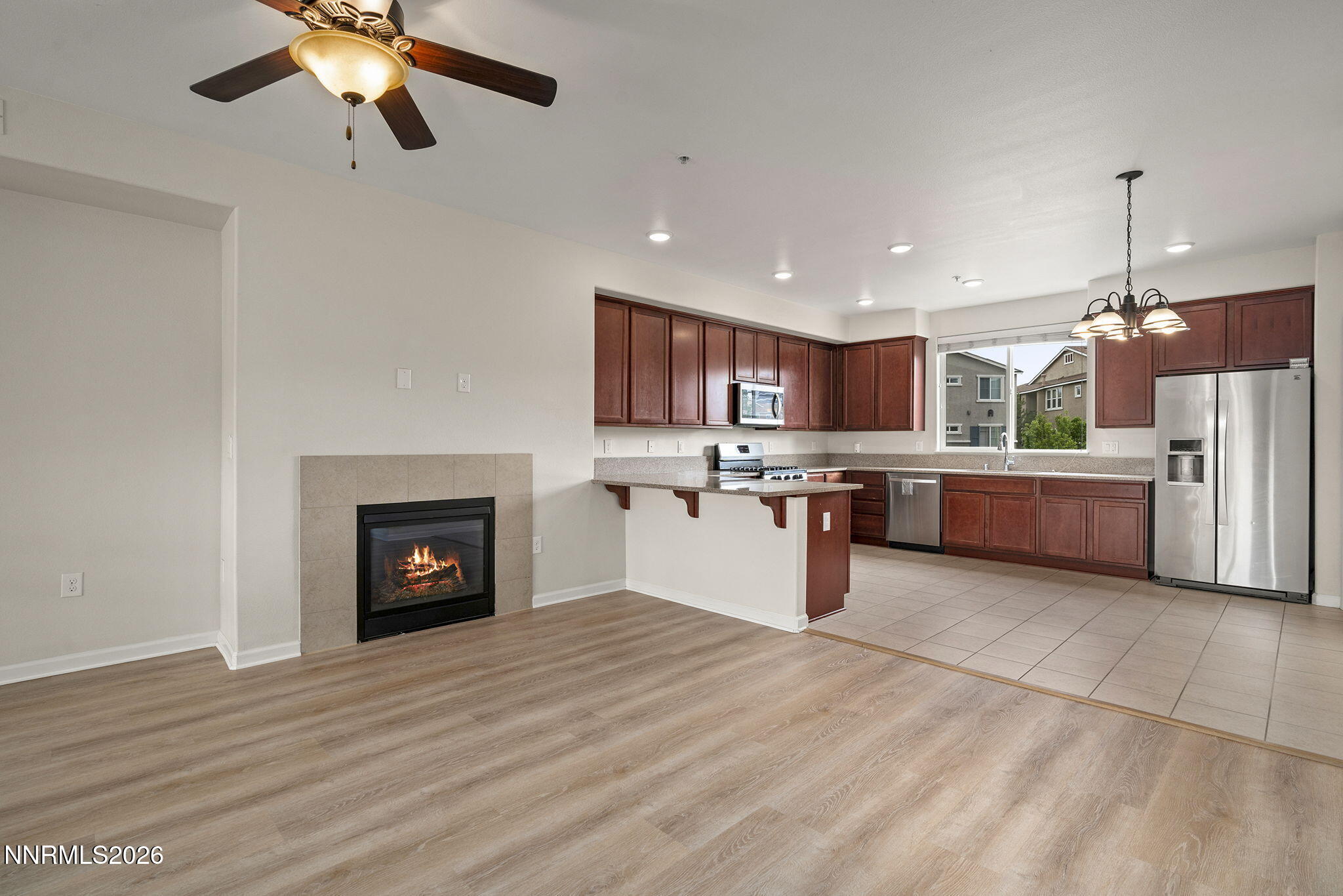 2490 Eastshore Place, Unit 104 Reno, NV 89509 - Photo 6 of 29 a open kitchen with a refrigerator a fireplace and a sink