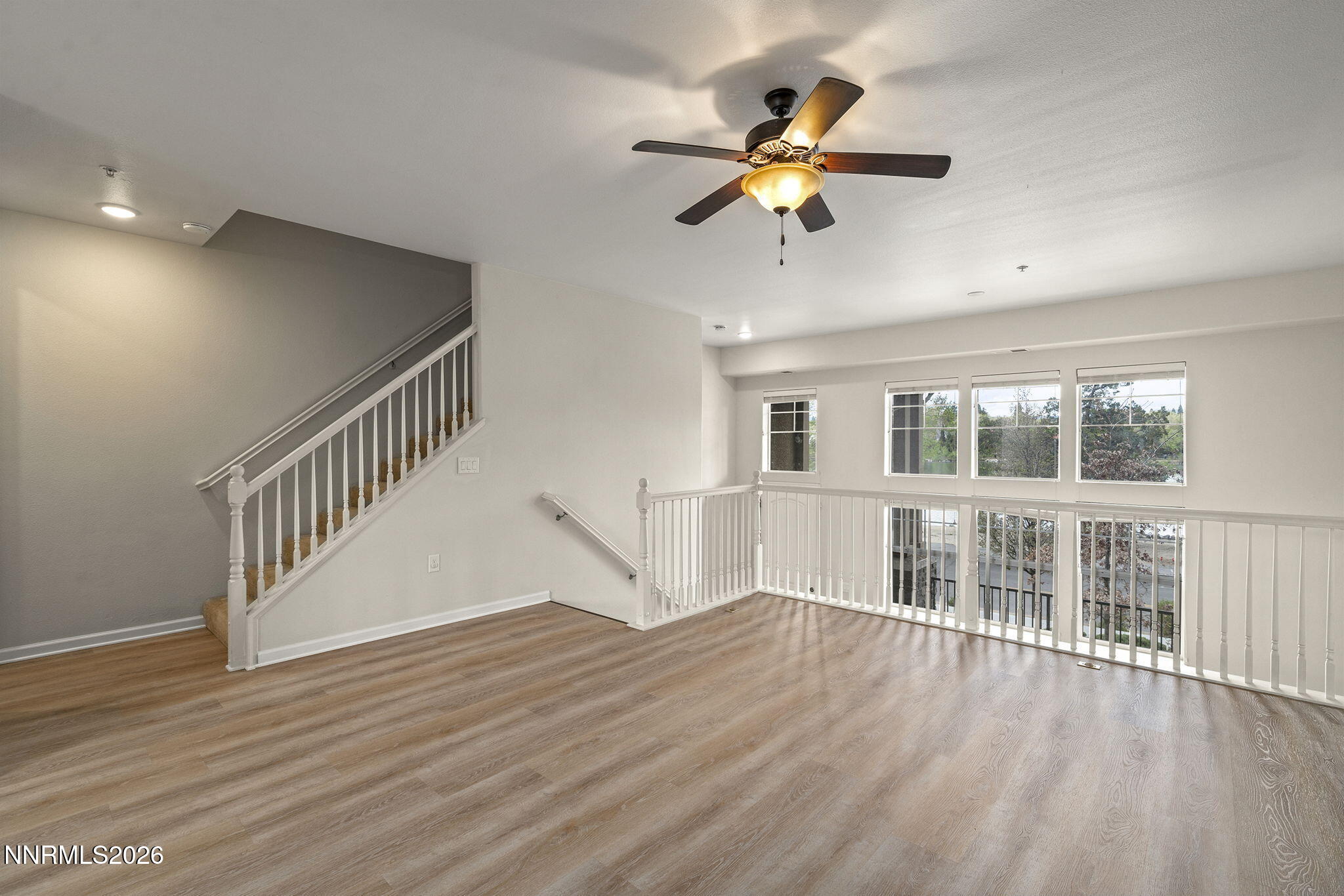 2490 Eastshore Place, Unit 104 Reno, NV 89509 - Photo 8 of 29 a view of an empty room with wooden floor and a window
