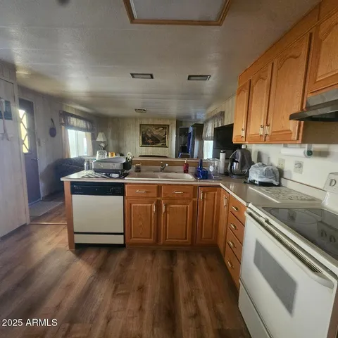 a kitchen with stainless steel appliances granite countertop a stove a sink dishwasher and a refrigerator